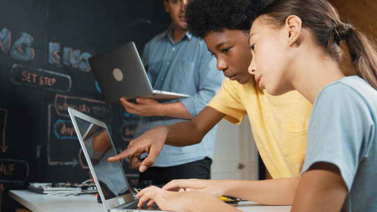 Students looking at computer screen 768x432